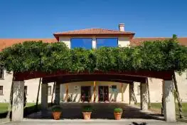 Entrada del hotel con pérgola cubierta de vegetación en Iberik Augas Santas Balneario & Golf