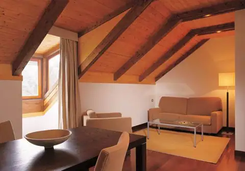 Suite abuhardillada con zona de estar y comedor en el Iberik Gran Balneario de Guitiriz